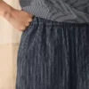 Pantalon à jambes évasées en lin et coton rayé